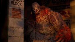 A large mutated zombie emerging from a doorway in State of Decay 3