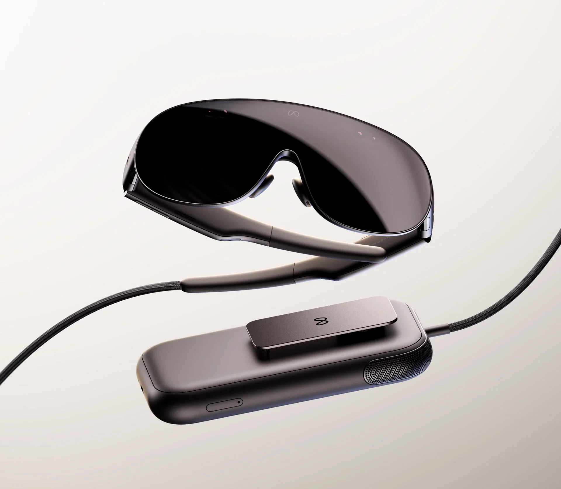 Meta VR Glasses beside the tethered compute puck and optical cable
