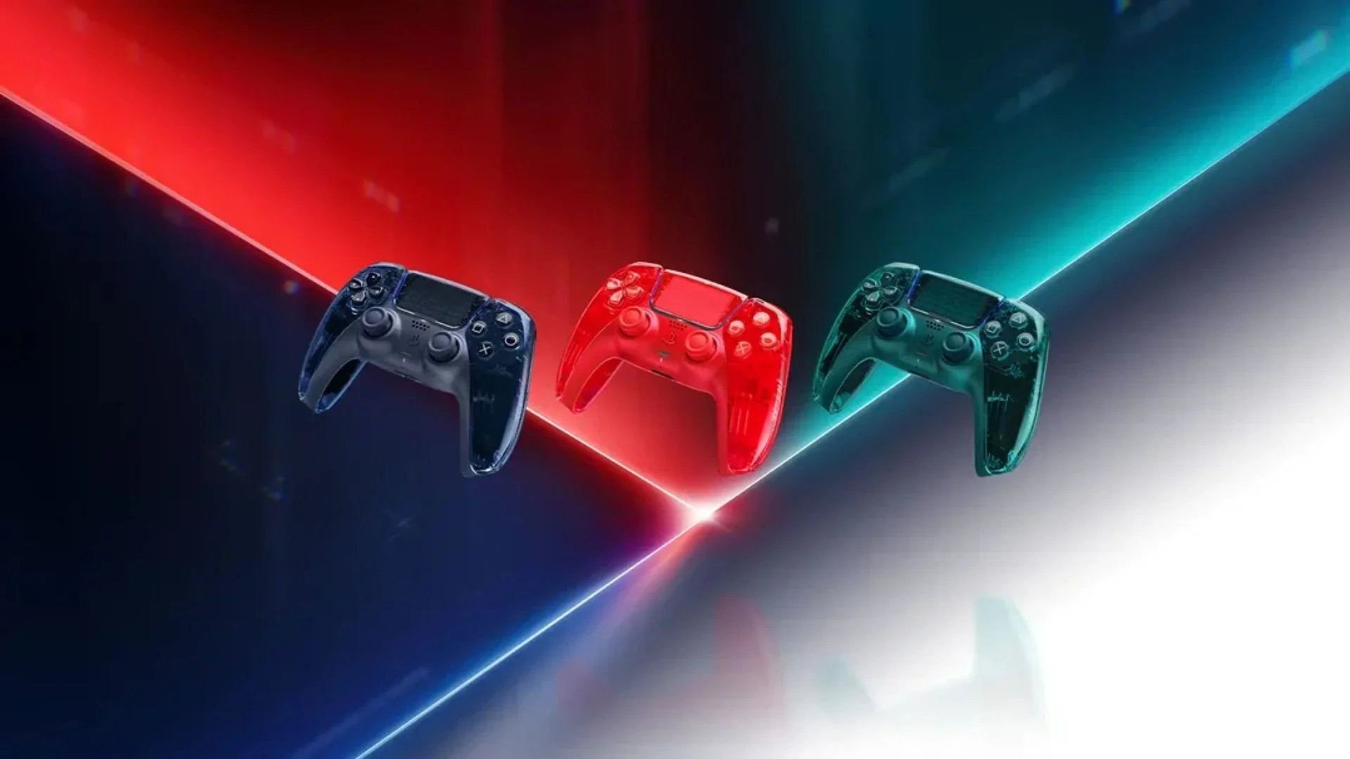 Three transparent DualSense wireless controllers in Graphite Gray, Flare Orange, and Emerald Green from the PS5 Prism Collection