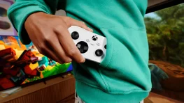 Person holding the compact white XBOX Nano Controller