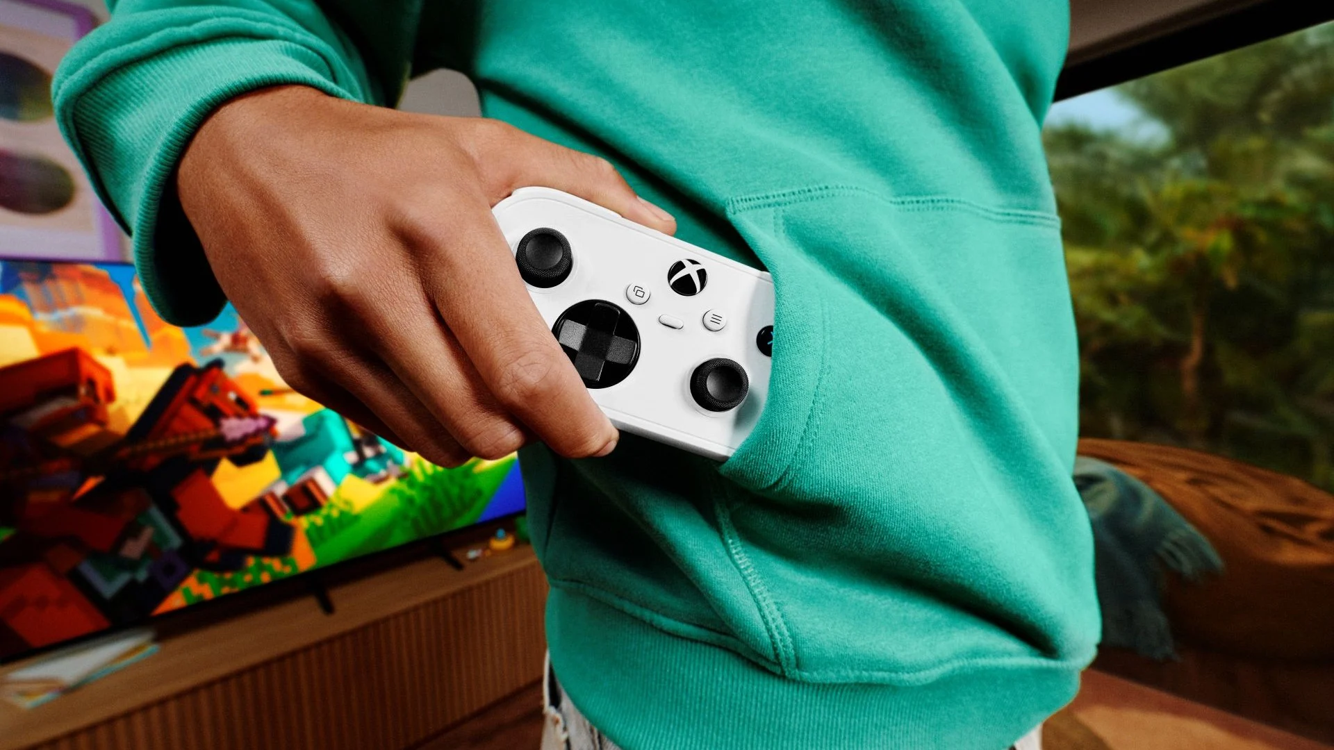 Person holding the compact white XBOX Nano Controller