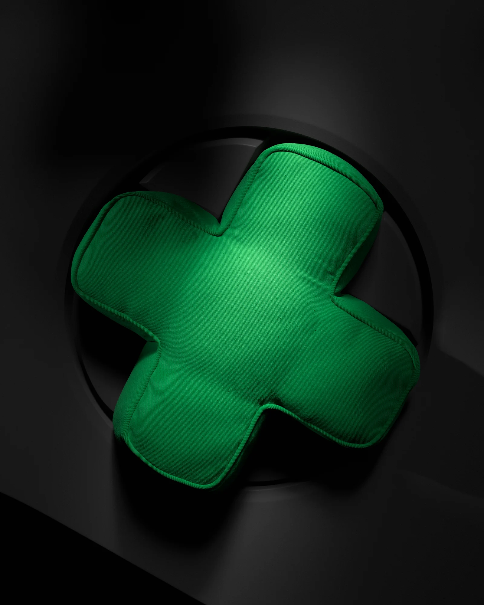 Green cross-shaped YXSTABY cushion inspired by the Xbox controller D-pad.
